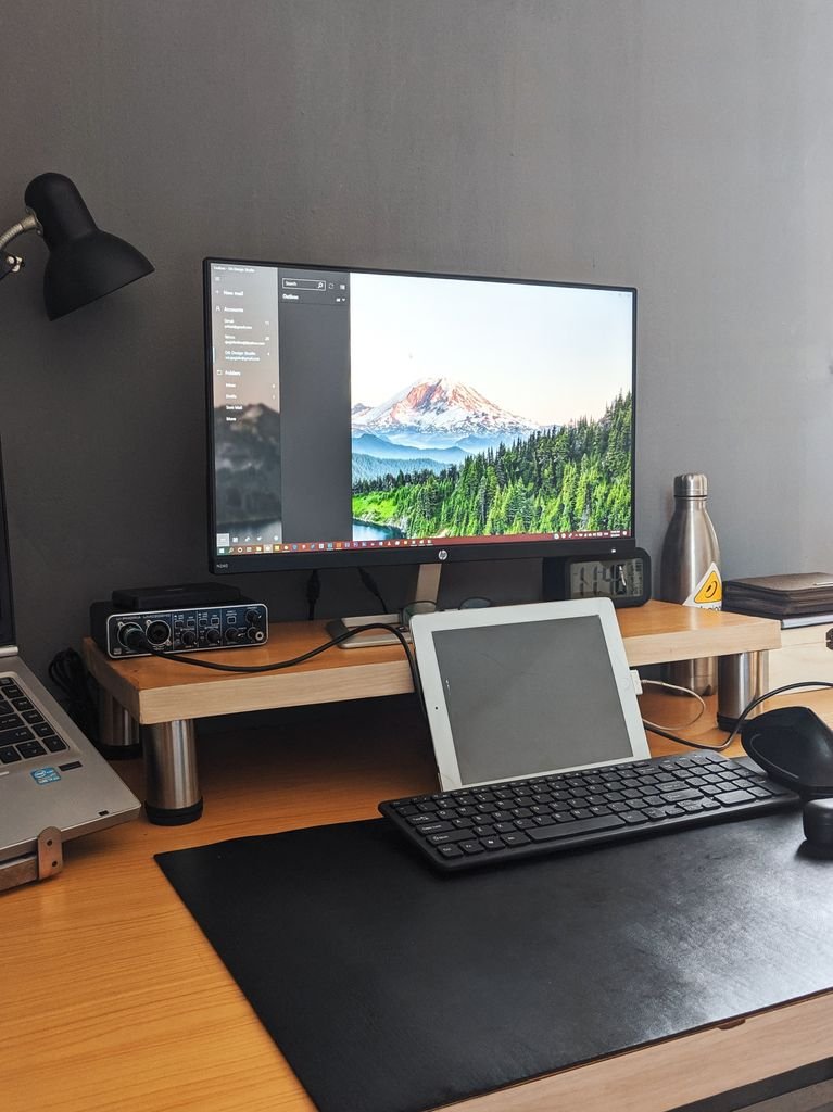 Desk organization ideas for a small apartment home office with monitor tablet and keyboard