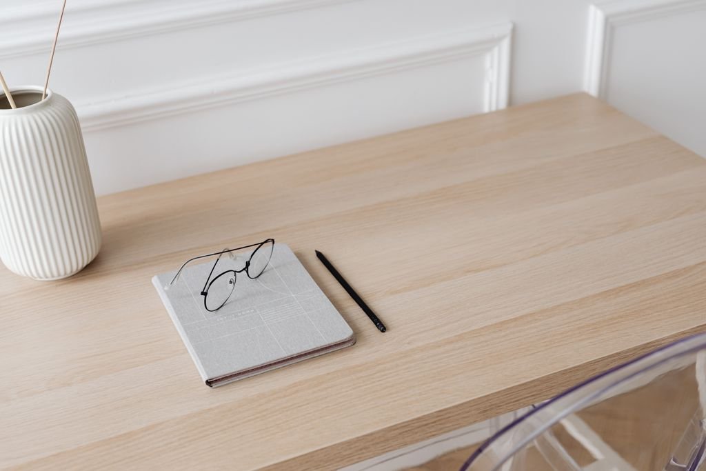 Renter friendly decor ideas for organizing a home office desk with a notebook and glasses